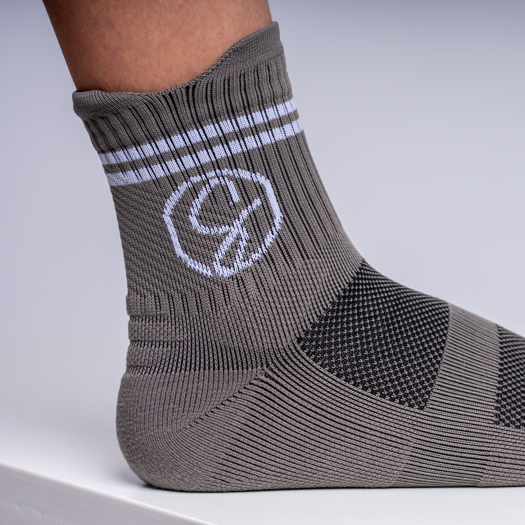 Gray sock with a logo on a light gray background