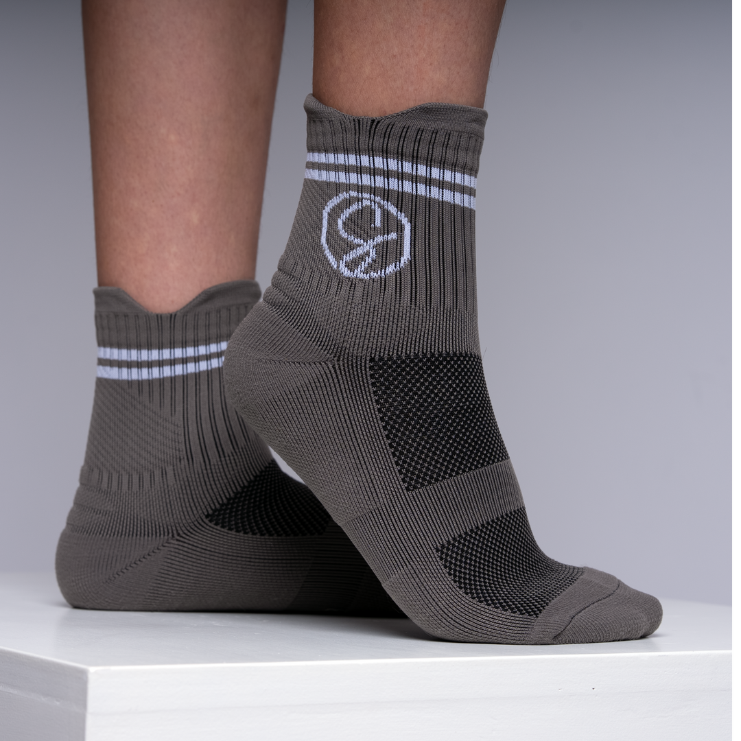Athletic Sport Gray socks with a logo on a neutral background
