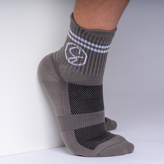 Gray ankle sock with a logo on a white background