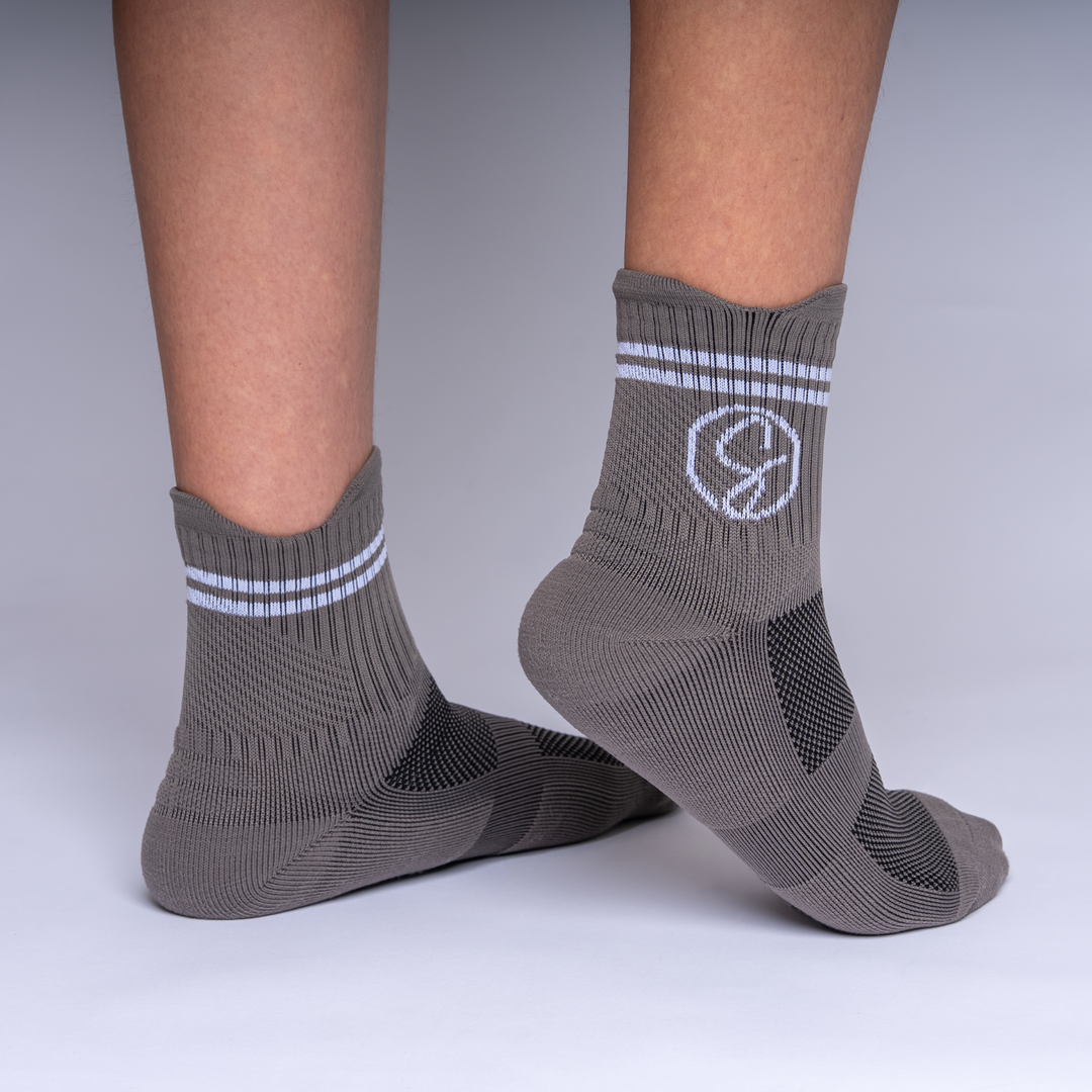 Gray socks with a symbol design on a neutral background
