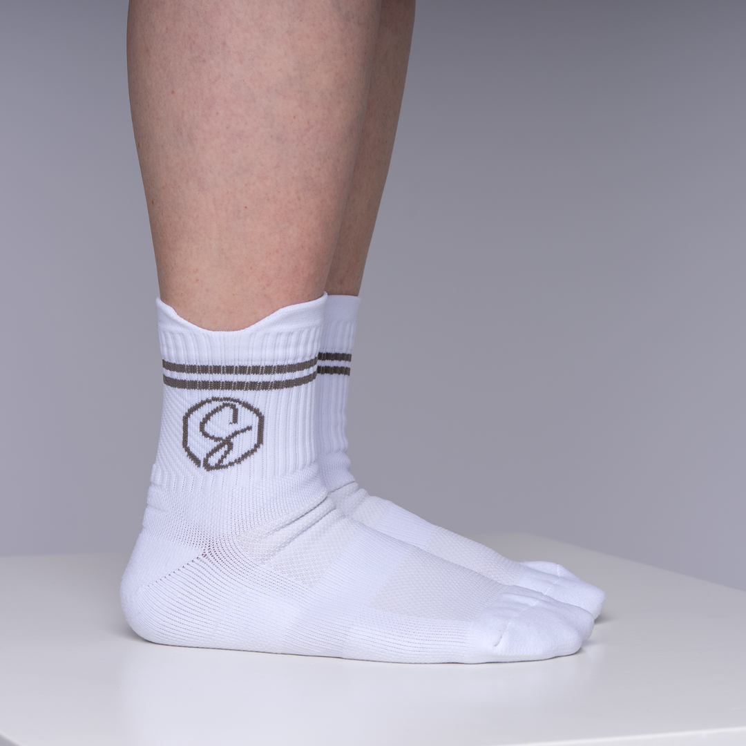 White socks with a logo on a neutral background