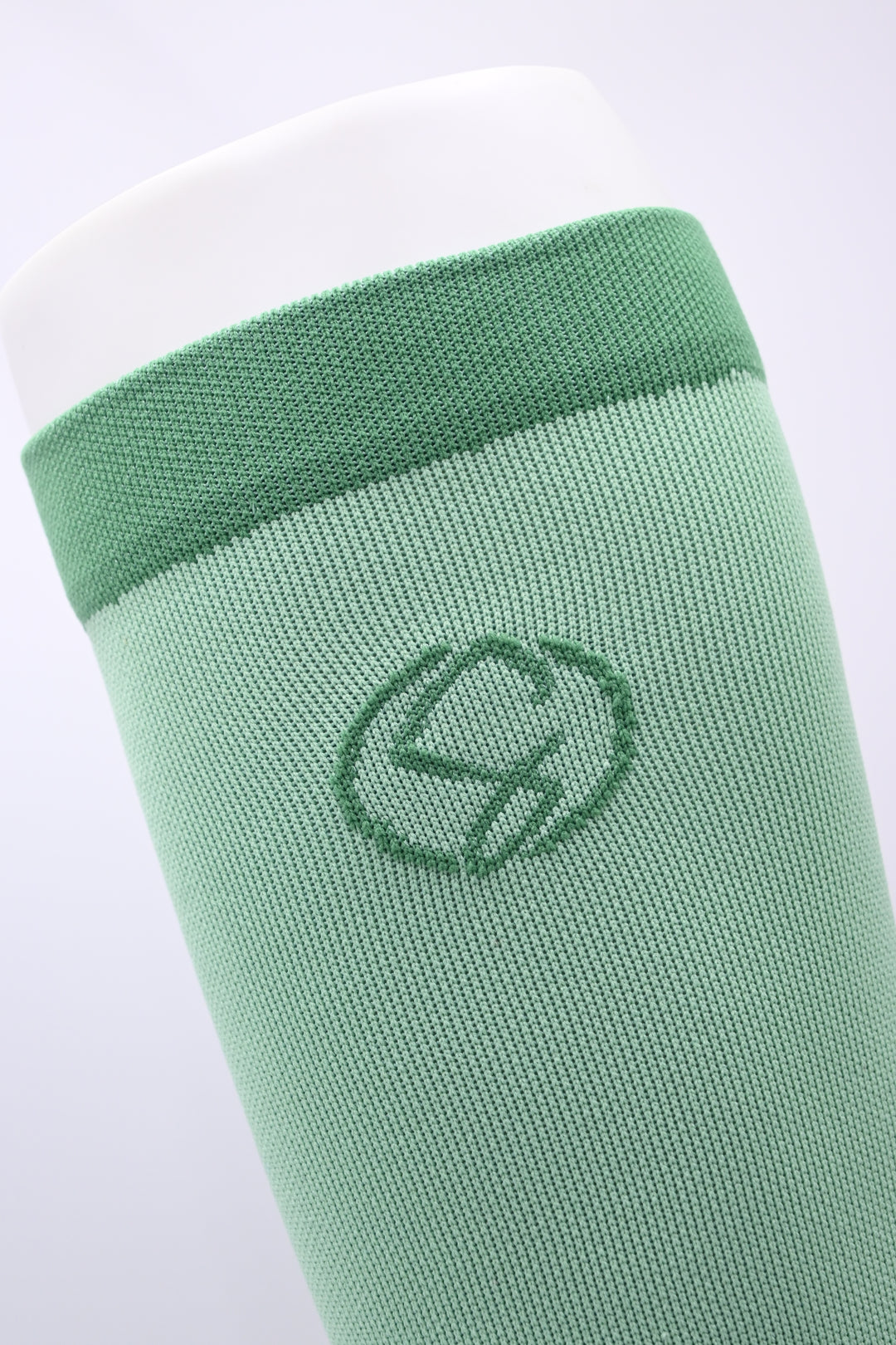 Green sock with a logo on a white background
