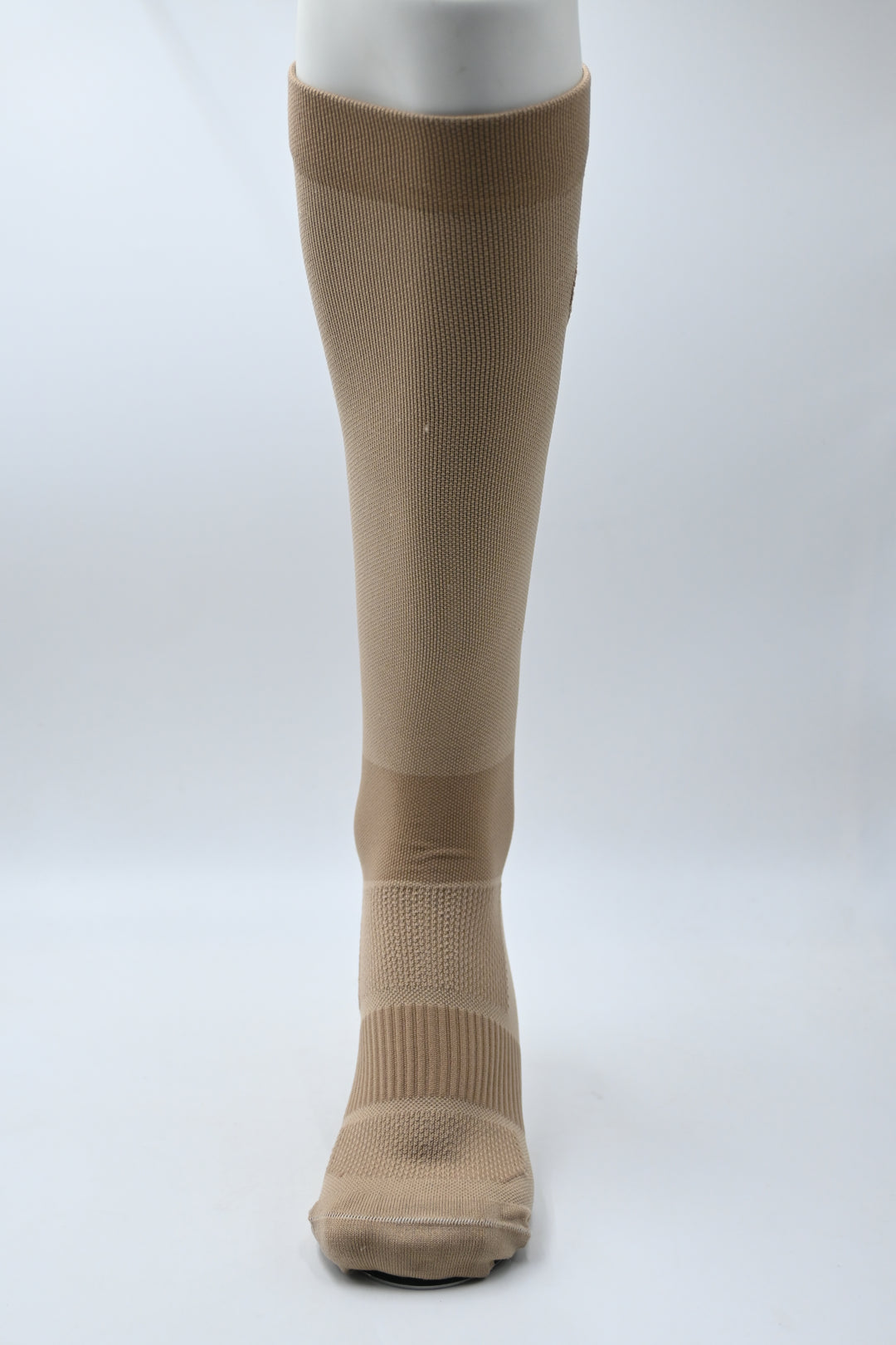 Brown compression stocking on a white background