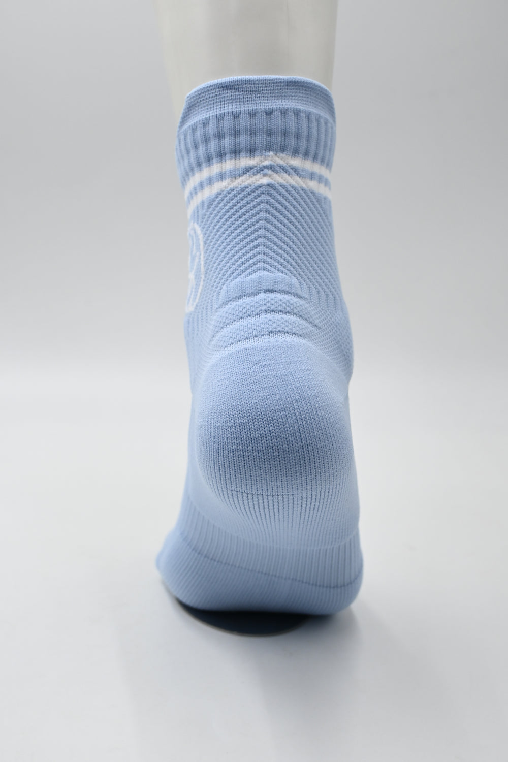 Athletic Sport blue socks with white stripes on a light gray background